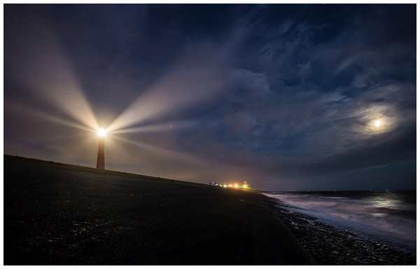 Shafts of light of the lighthouse spotting different directions.